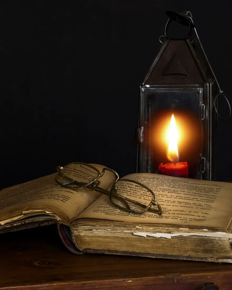 Ancient text studied by candlelight — astrology consultation with Master Vishnu in Houston